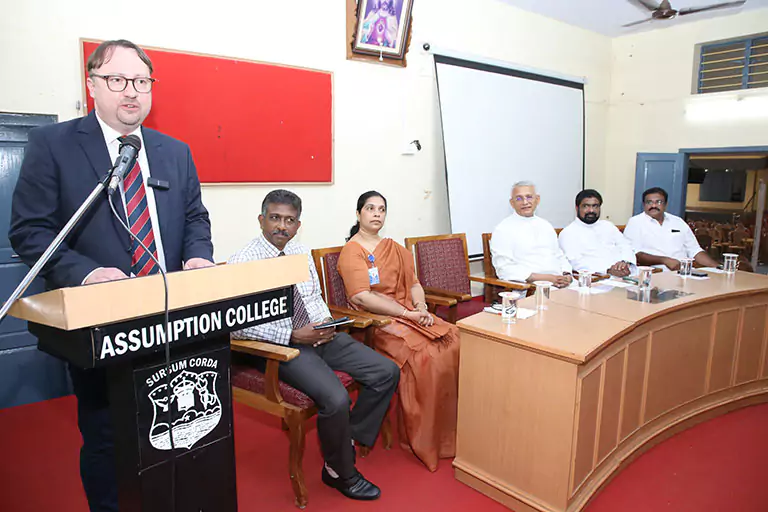 Traum academic orientations team and speakers at Assumption College podium